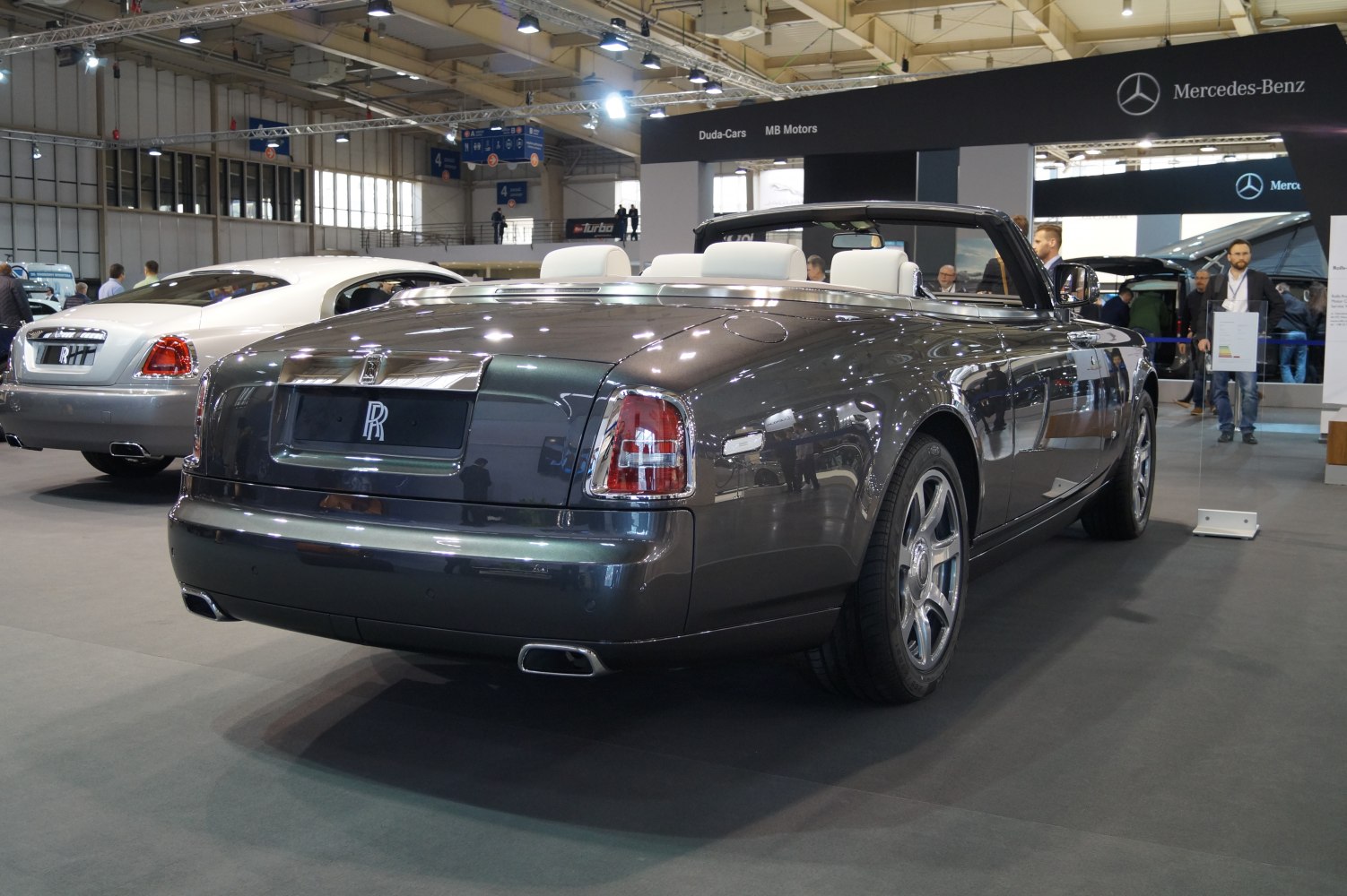 Rear view of luxury convertible with distinctive tail lights and dual exhausts