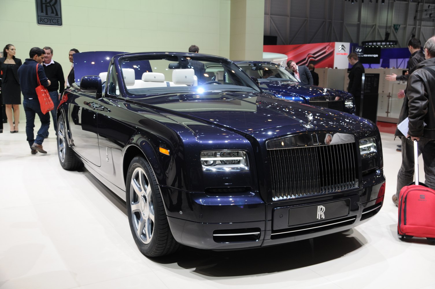 Luxury convertible with sleek front grille and white leather interior