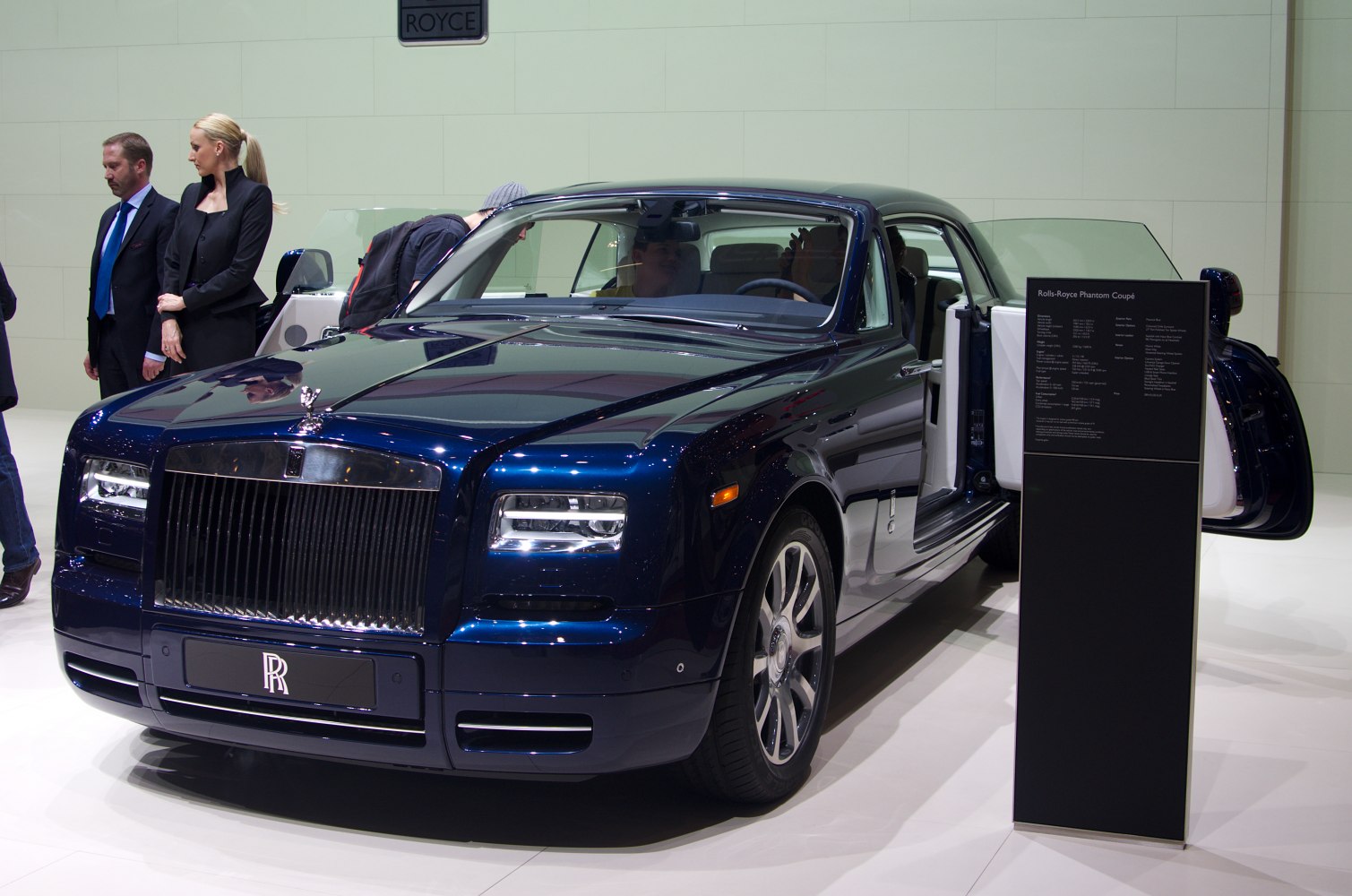 Front grille, LED headlights, and coach doors open on luxury coupe