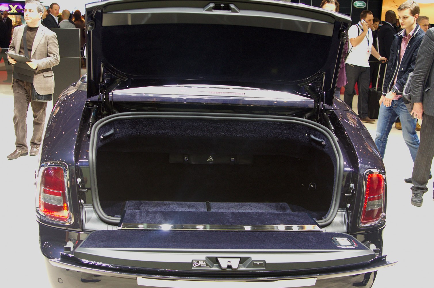 Spacious open trunk interior of a luxury coupe with high-quality lining.