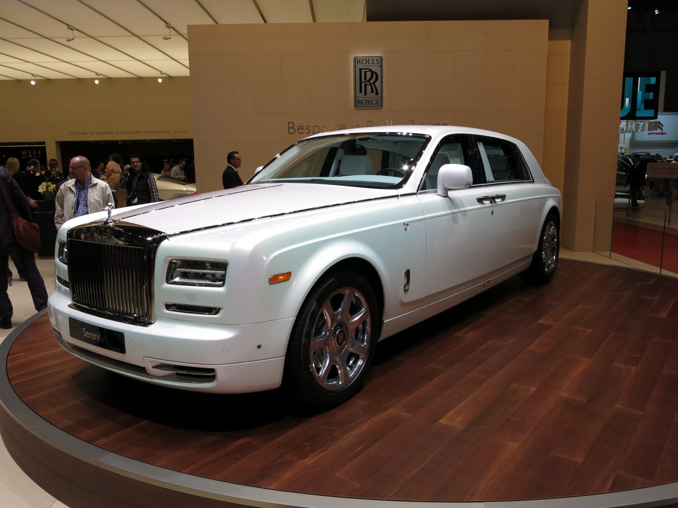 White extended wheelbase luxury sedan with chrome grille and wheels