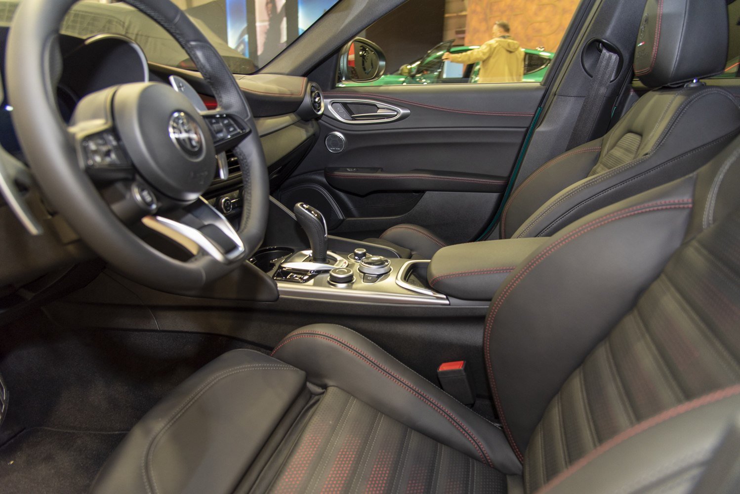 Leather seats with red stitching, gear shift lever, and advanced center console controls