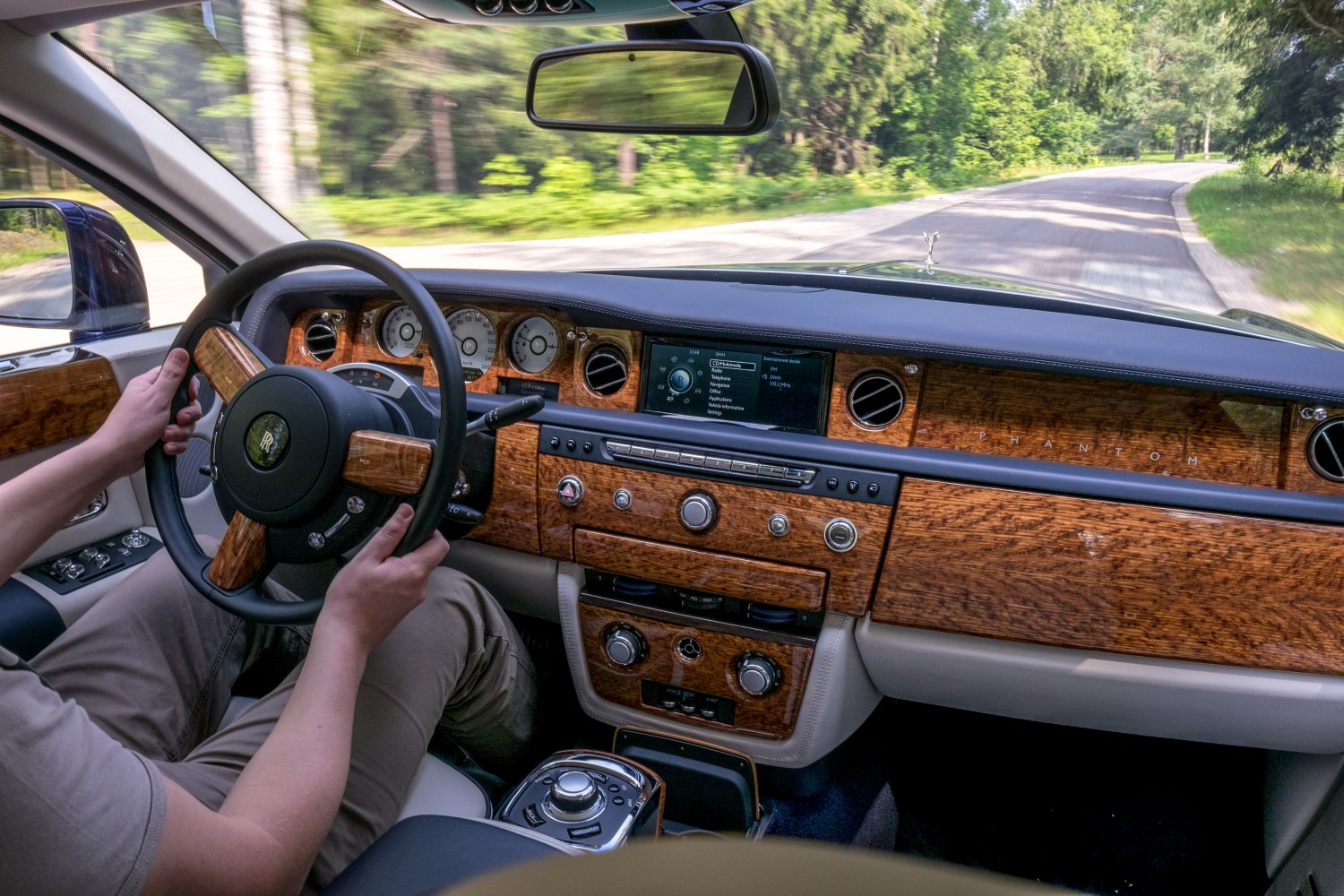 Wood-trimmed dashboard and steering wheel with analog gauges