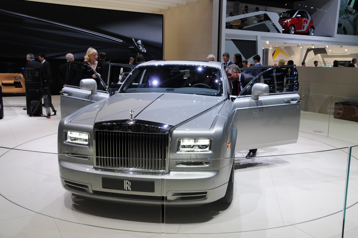 Front view of luxury sedan with open doors and prominent grille