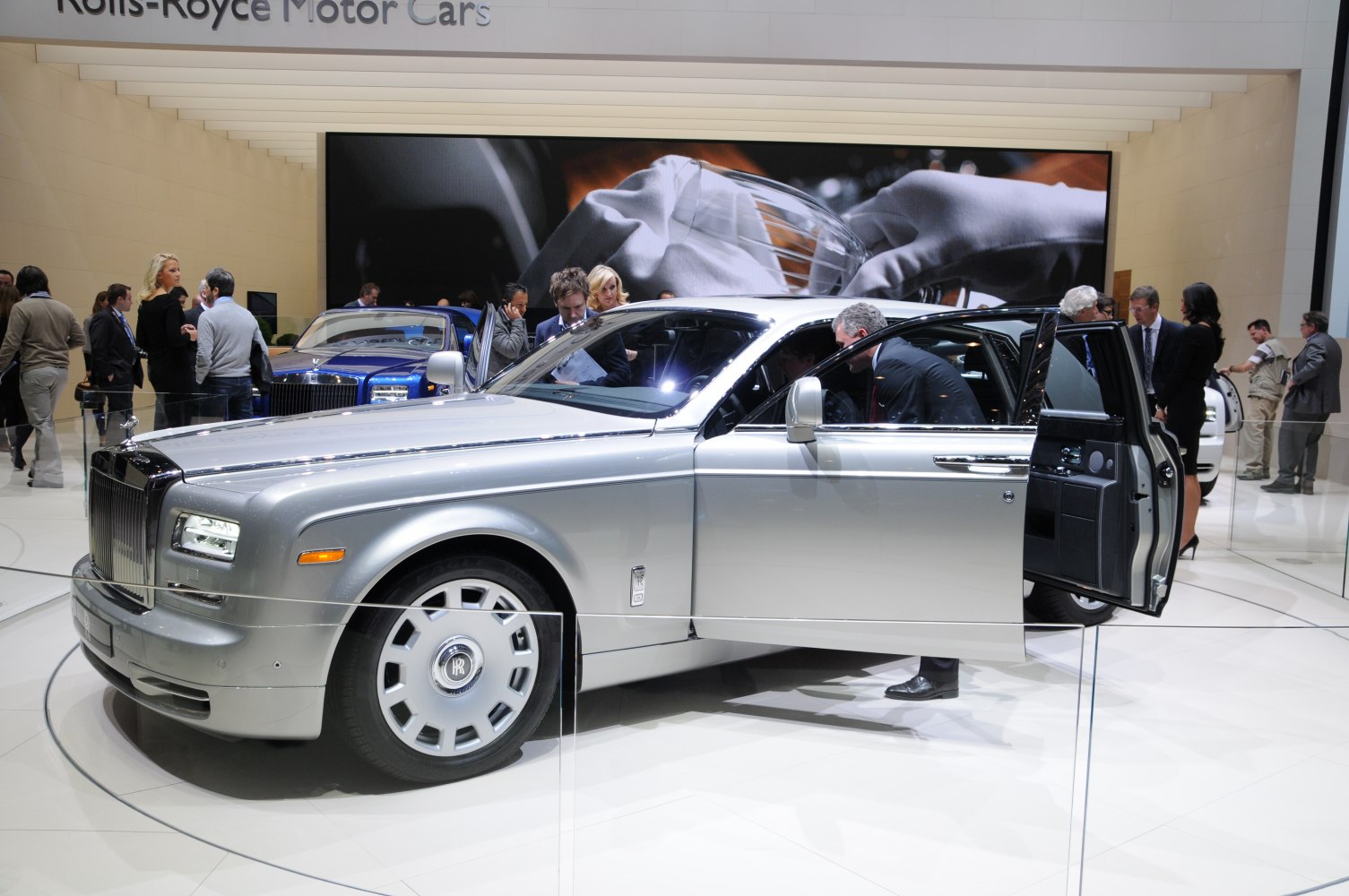 Silver luxury sedan with rear-hinged doors and classic luxury design