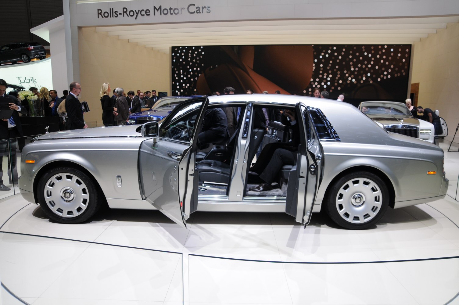 Silver luxury sedan with rear-hinged doors and premium interior