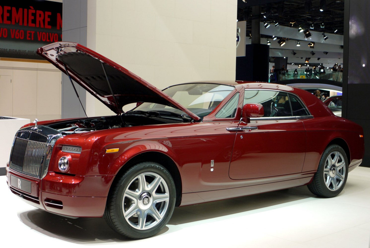 Luxury coupe with open hood revealing engine and detailed front view