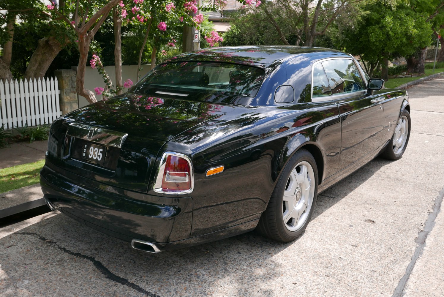 Luxury coupe rear and side view with distinct tail lights and chrome accents