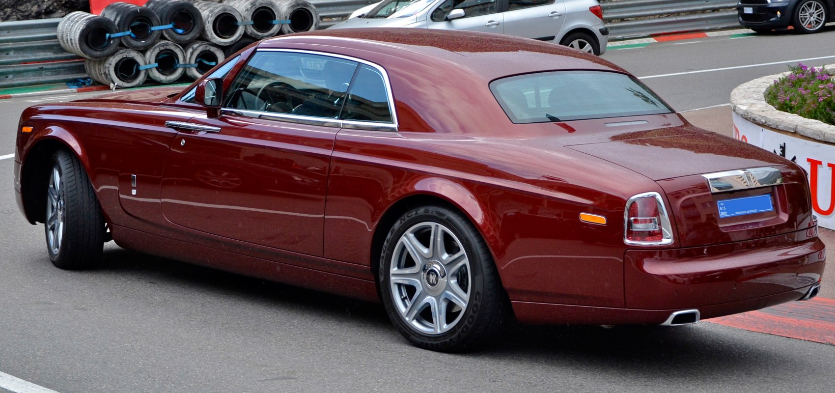 Rear side profile of luxury coupe with chrome trim and silver wheels