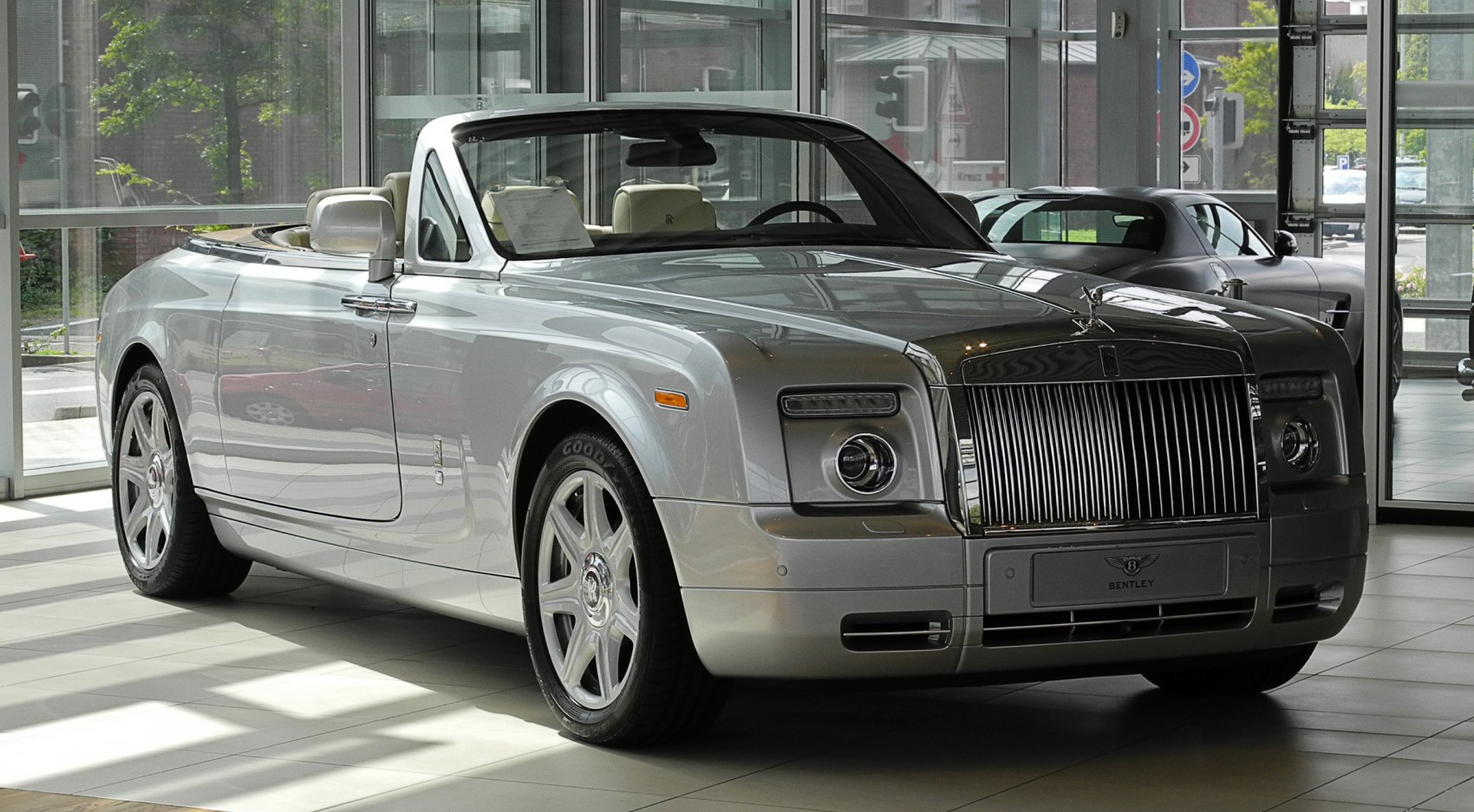 Luxury convertible with chrome vertical grille and open roof design
