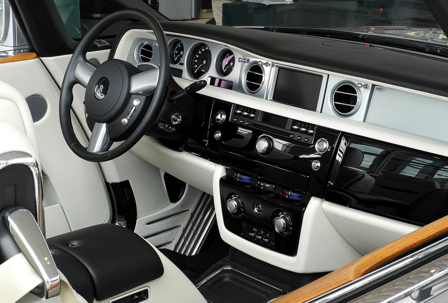 Luxury dashboard and steering wheel with analog gauges and wood trim