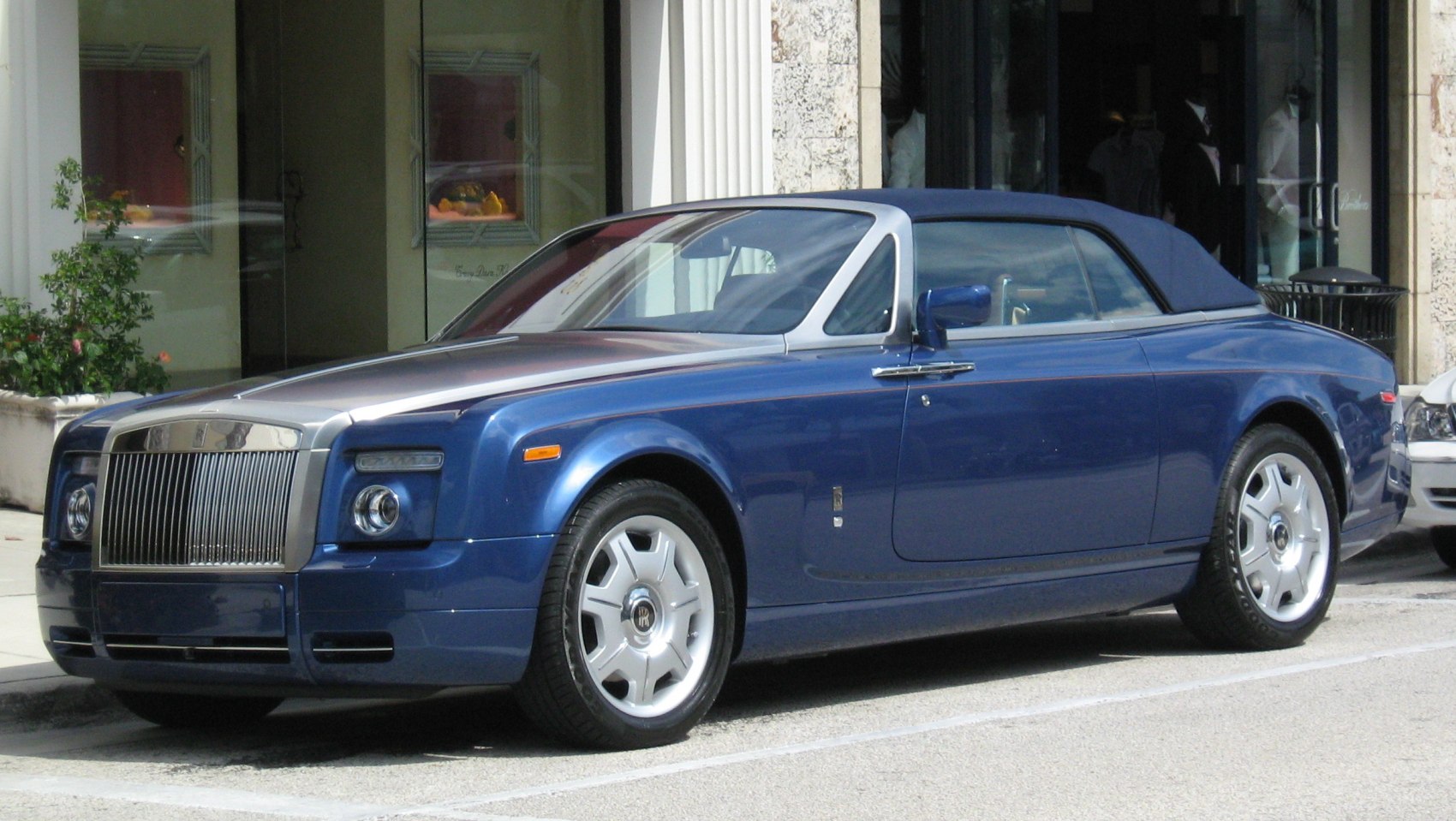 Luxury blue convertible coupe with signature front grille and silver accents
