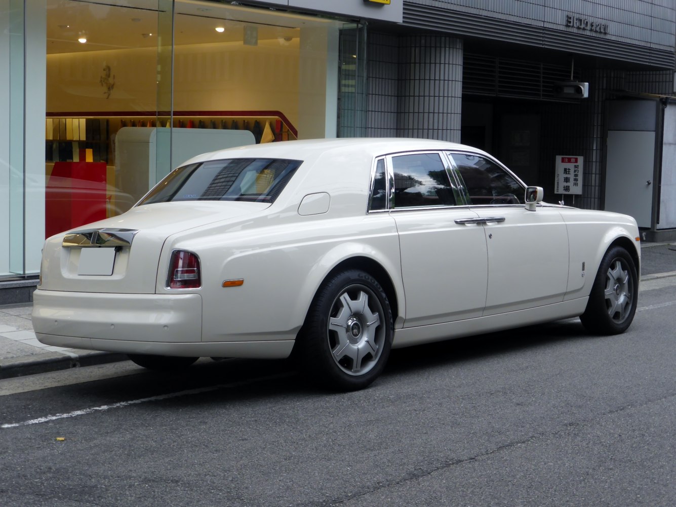 Luxury white sedan with chrome trim and distinctive rear design