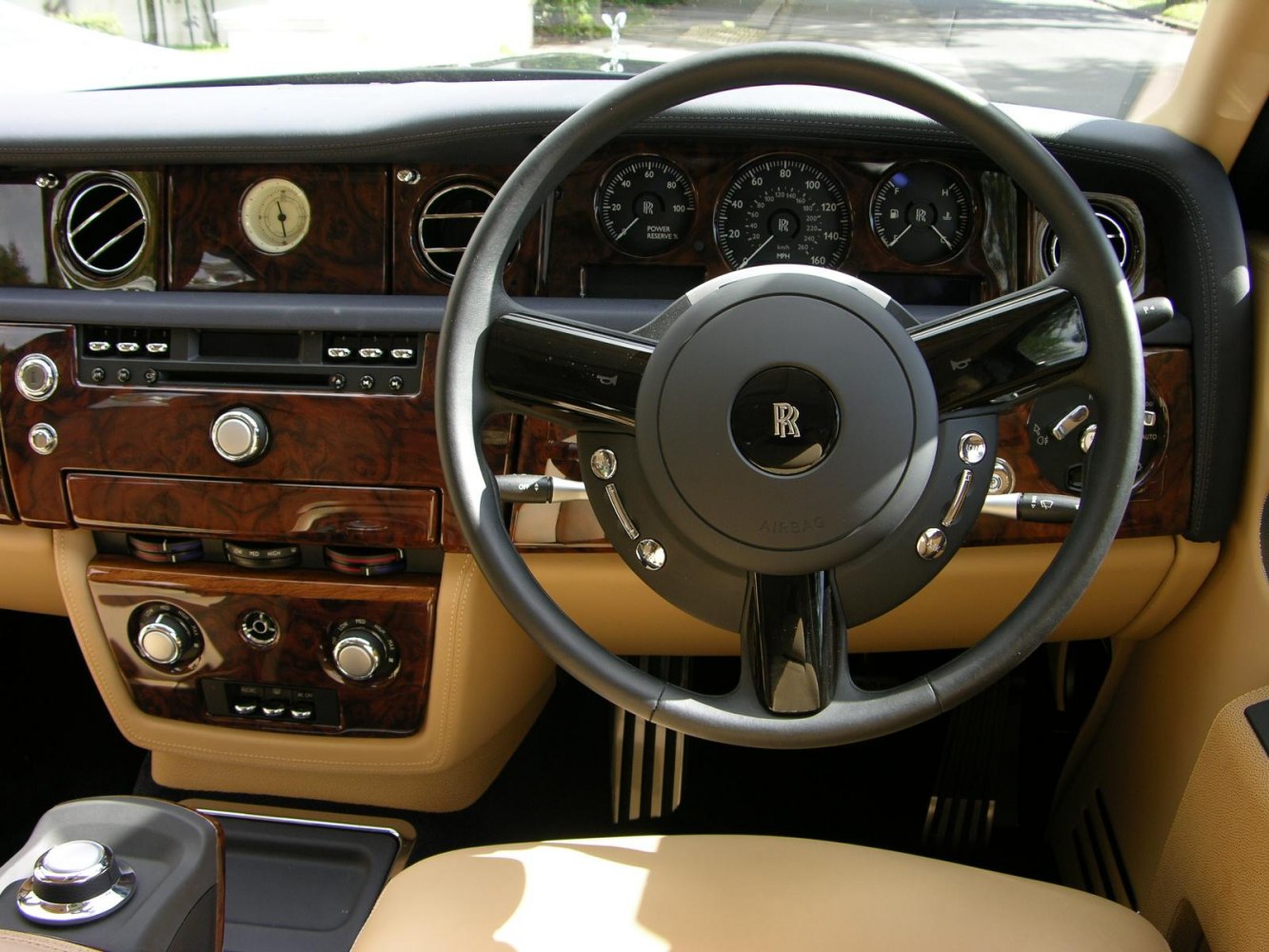 Luxury dashboard and steering wheel with wood trim and analog clock