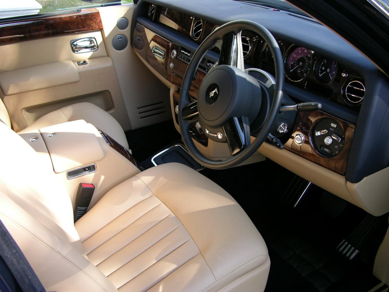 Luxury beige leather interior with wood trim and classic dashboard