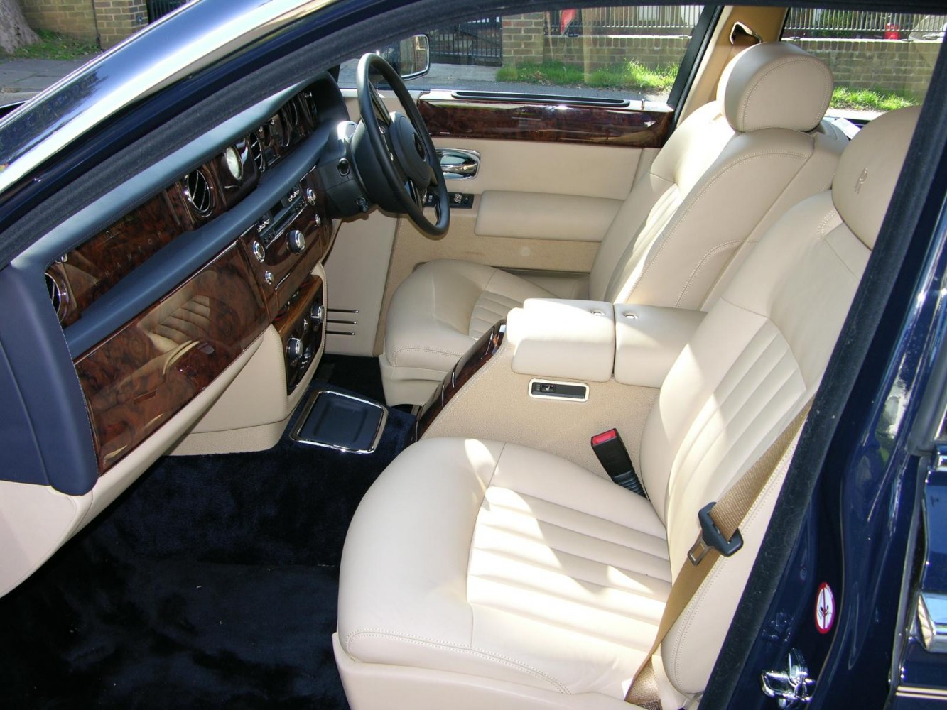 Beige leather seats and wood grain dashboard trim