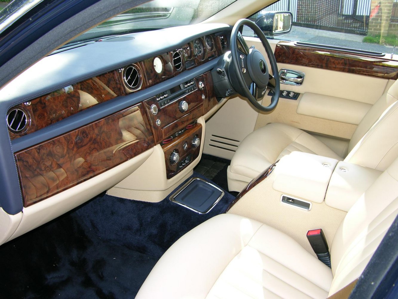 Luxurious wood trim dashboard and cream leather seats in vintage luxury sedan