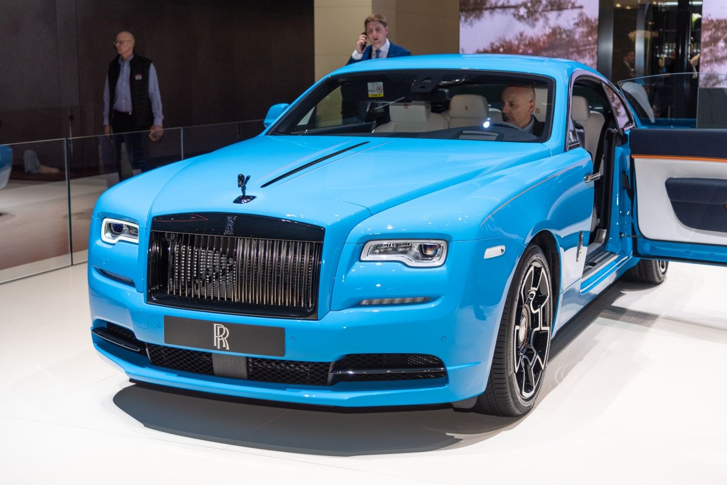 Luxury blue coupe with vertical grille and Spirit of Ecstasy hood ornament