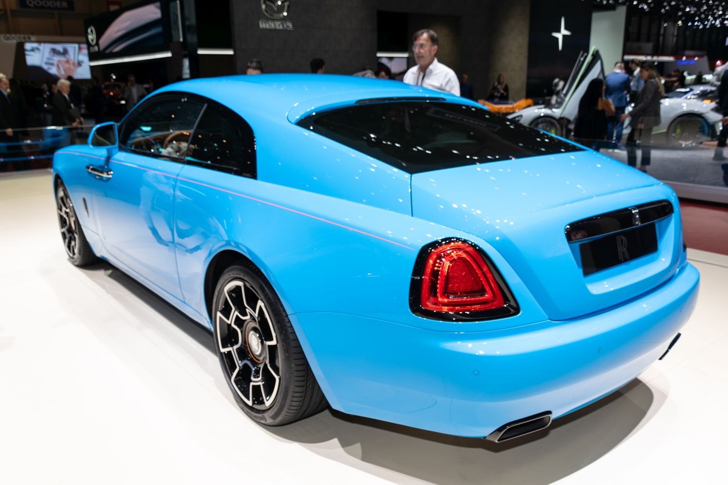 Rear profile of a luxury coupe with distinctive taillights and black alloy wheels in blue.