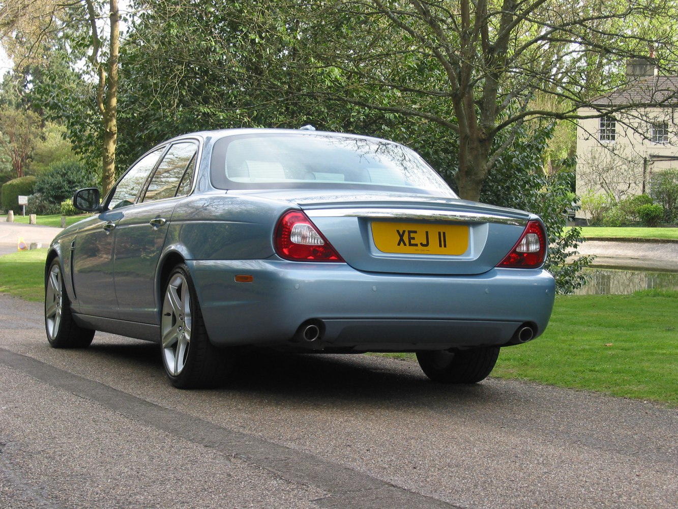 Luxury sedan rear with dual exhaust and unique taillights
