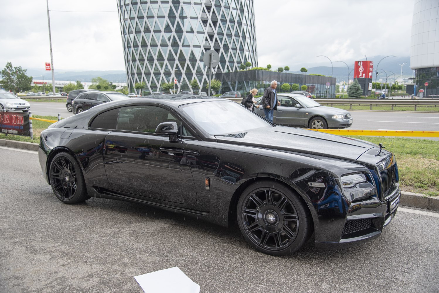 Black luxury coupe with bold grille and sleek aerodynamic shape