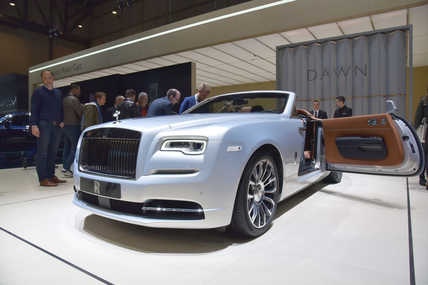 Luxury convertible with open driver’s side door and premium design.