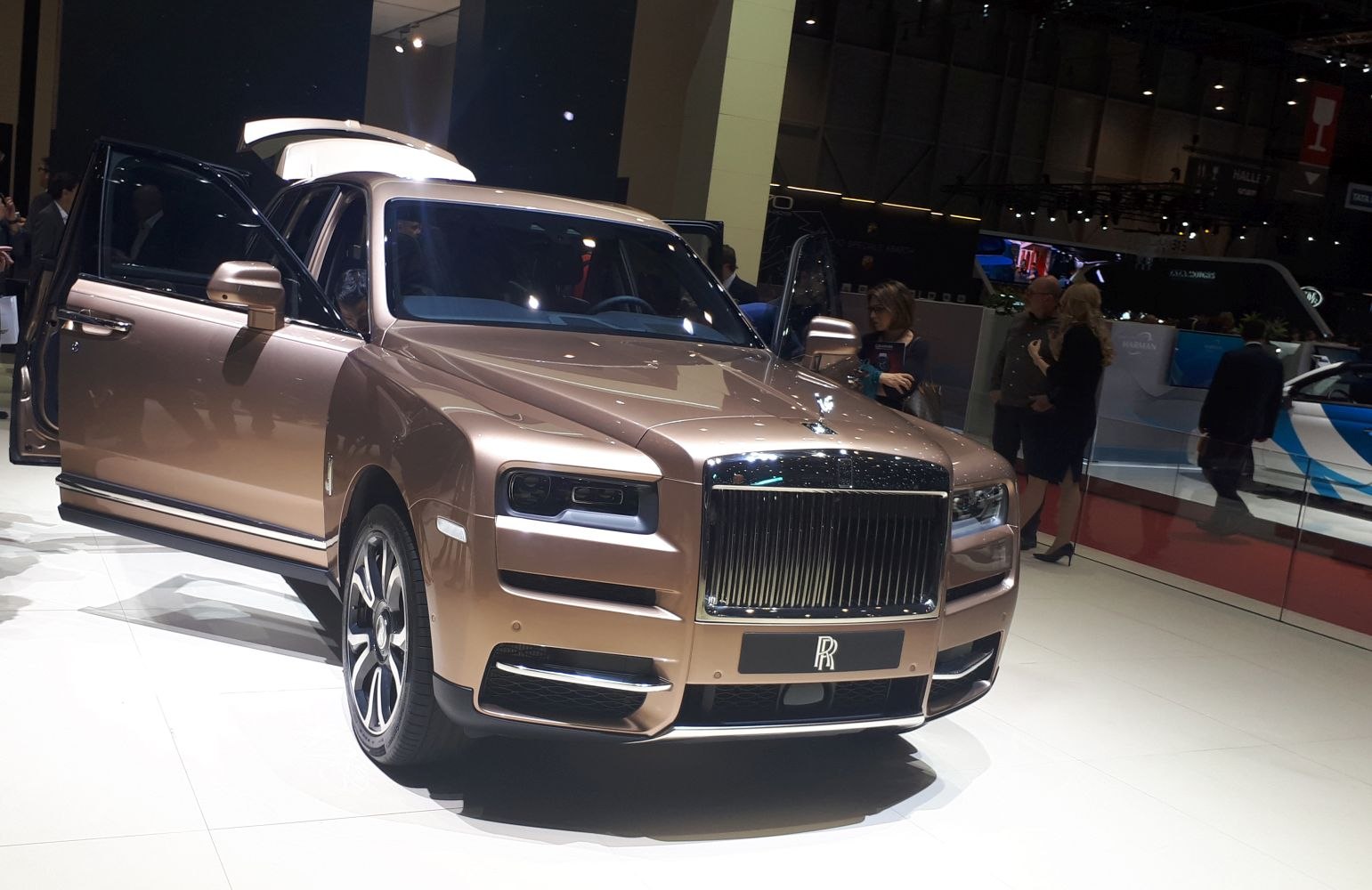 Luxury SUV front with signature grille and open doors