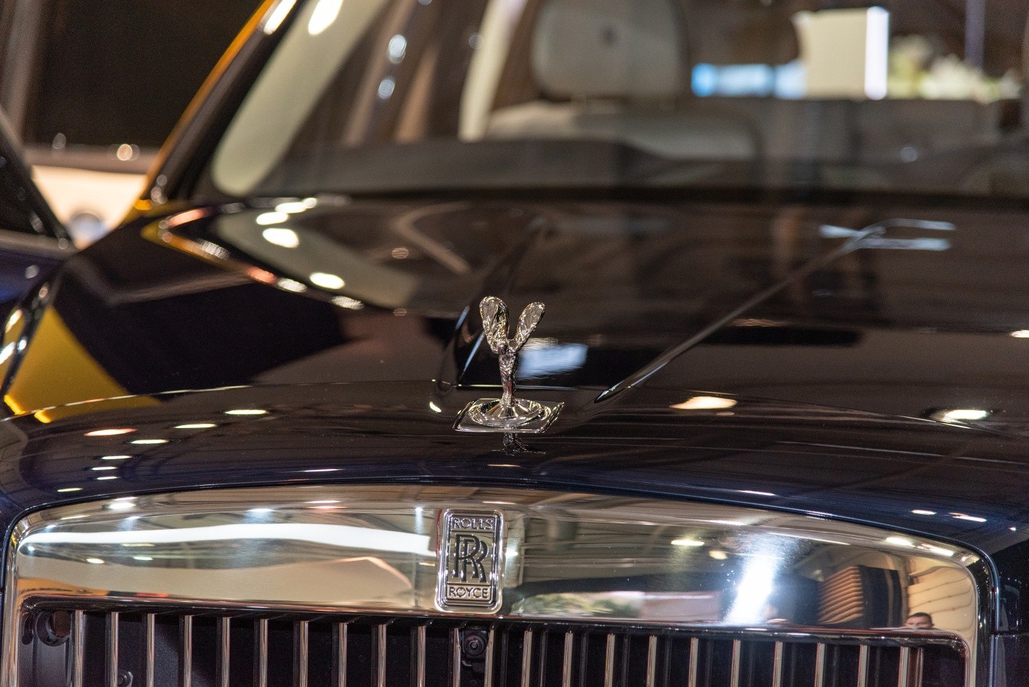 Close-up of a luxury hood ornament and front grille