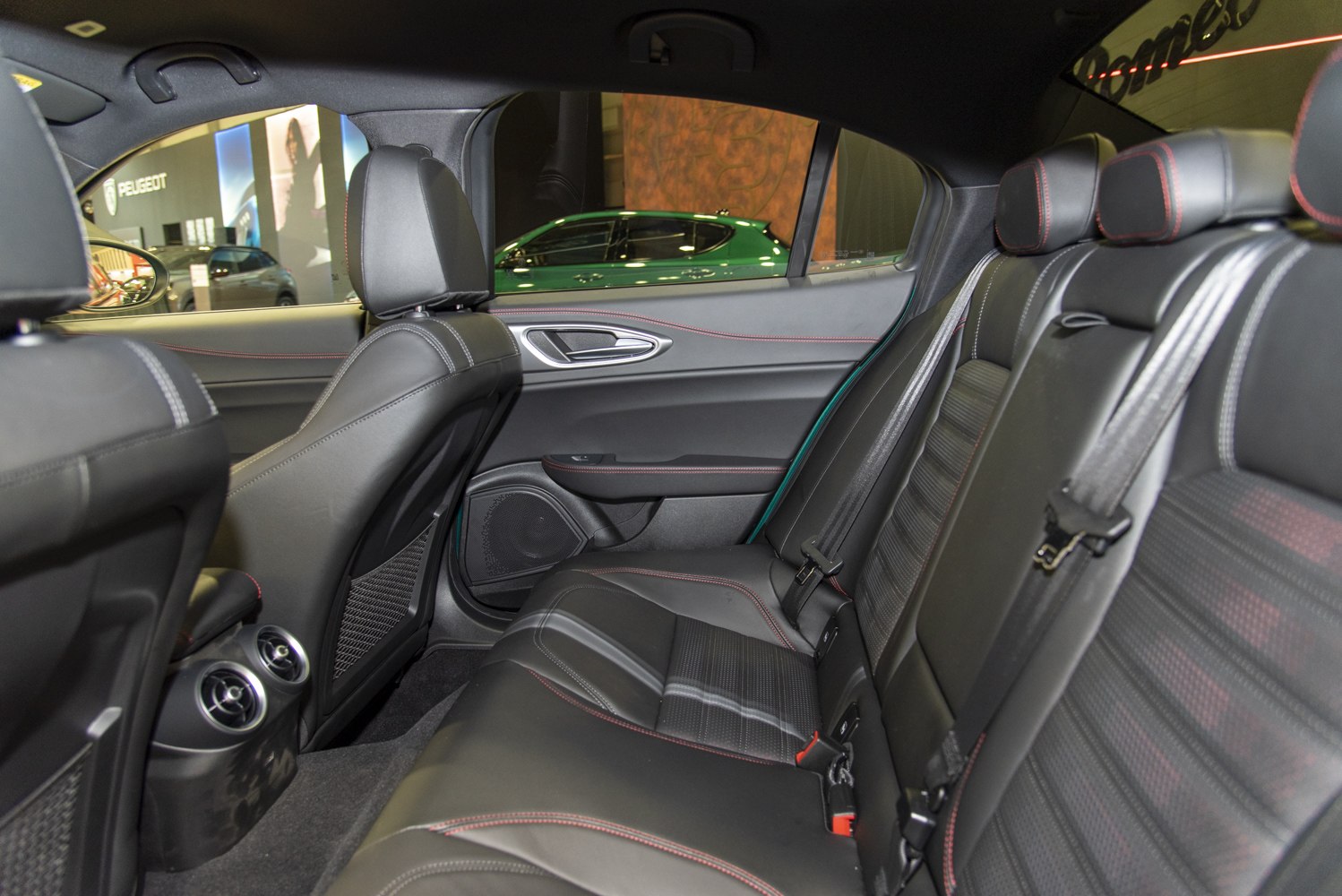 Rear leather seats with red stitching and rear air vents