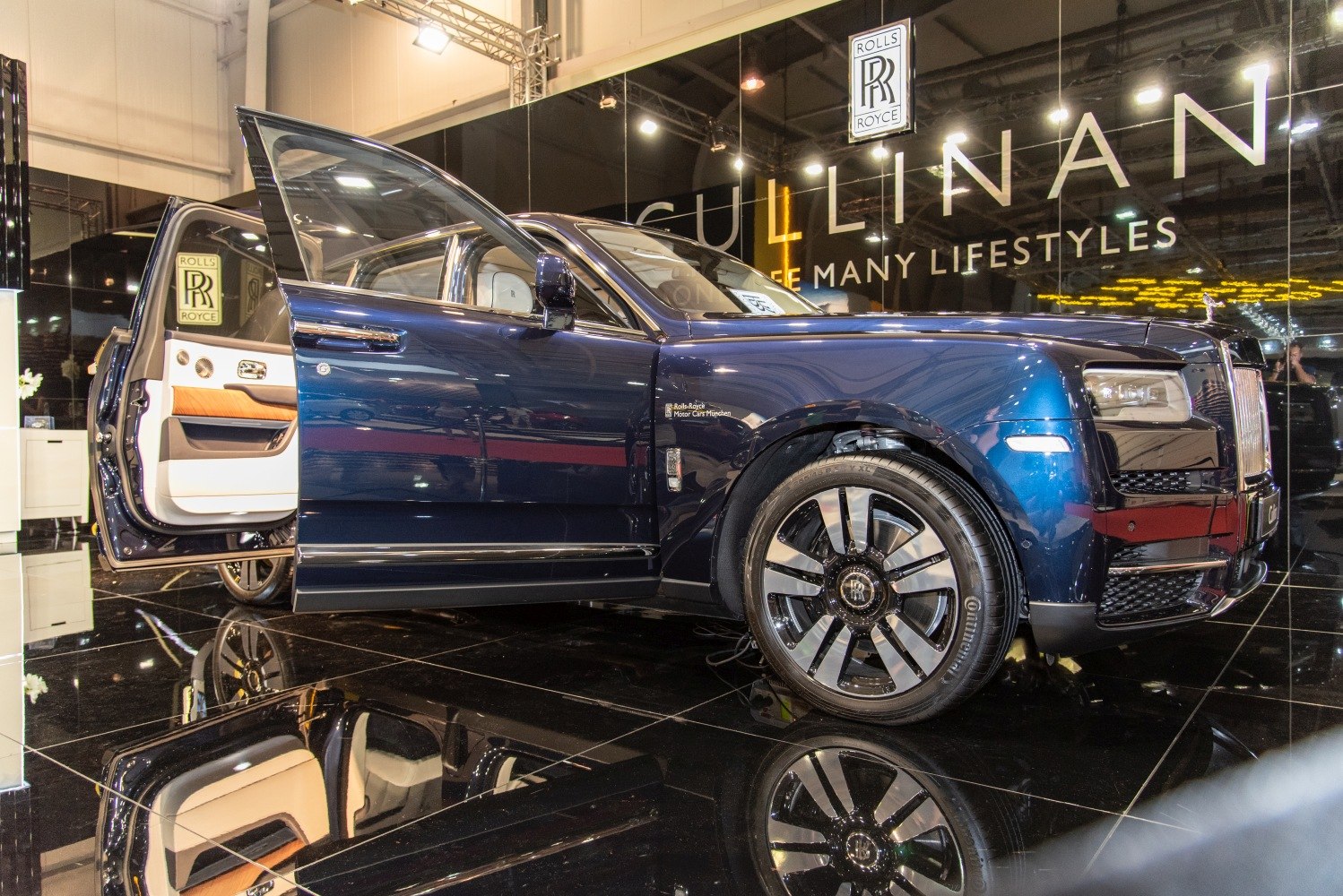 Luxury SUV with rear-hinged coach doors and stylish wheel.