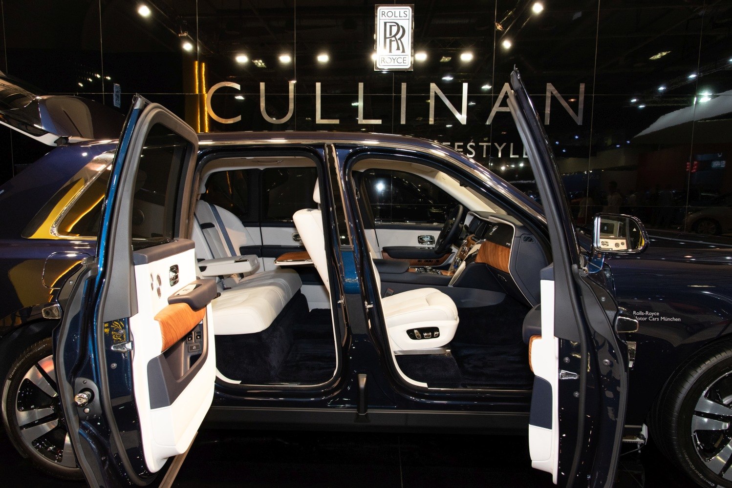 Opulent SUV interior featuring rear-hinged coach doors and premium leather seats