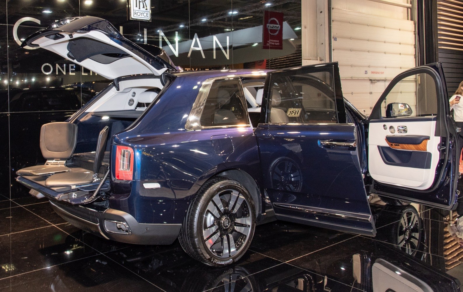 Luxury SUV rear tailgate seating with open doors and premium interior