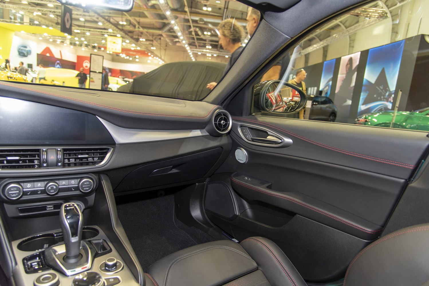 Interior dashboard, gear shift, and door details with red stitching