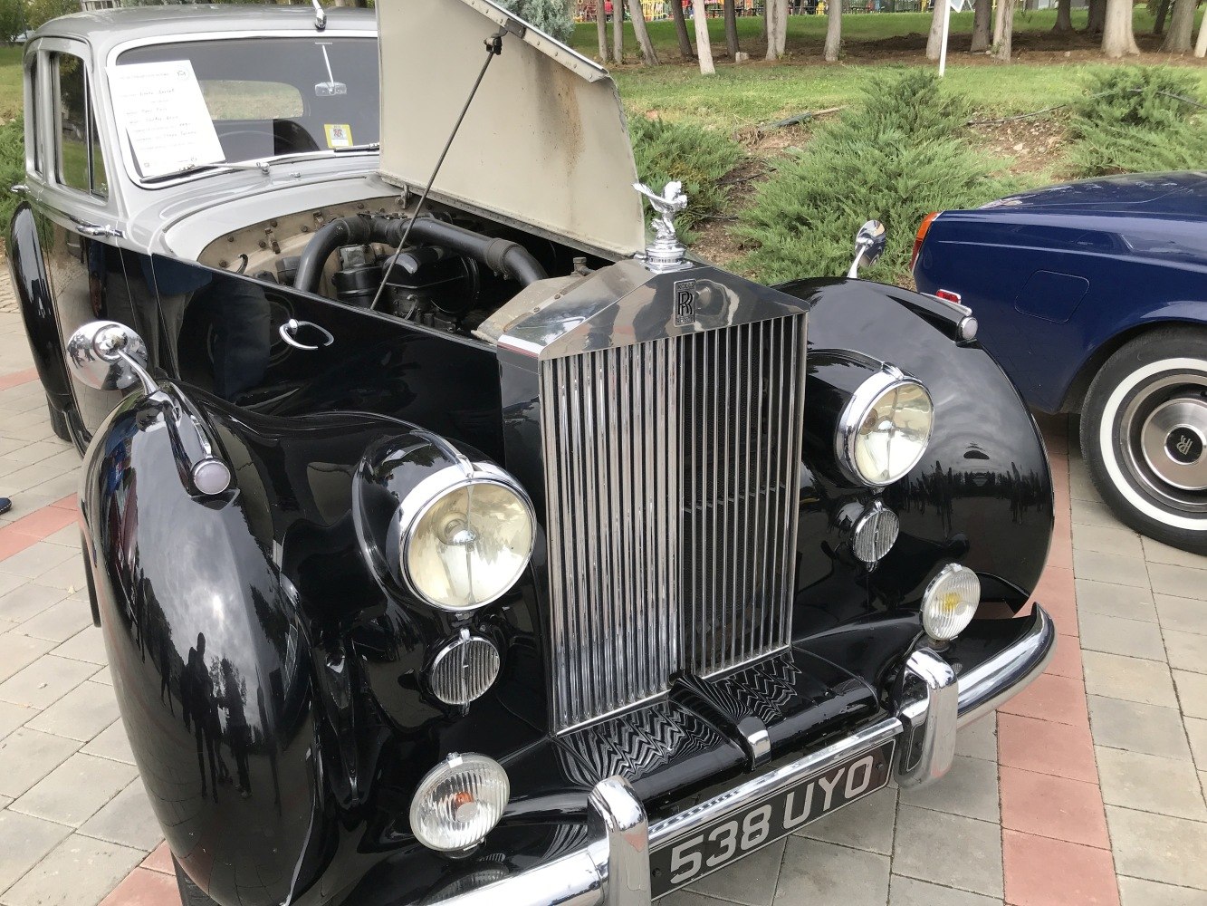 Classic front with open bonnet and visible engine, prominent grille and headlights