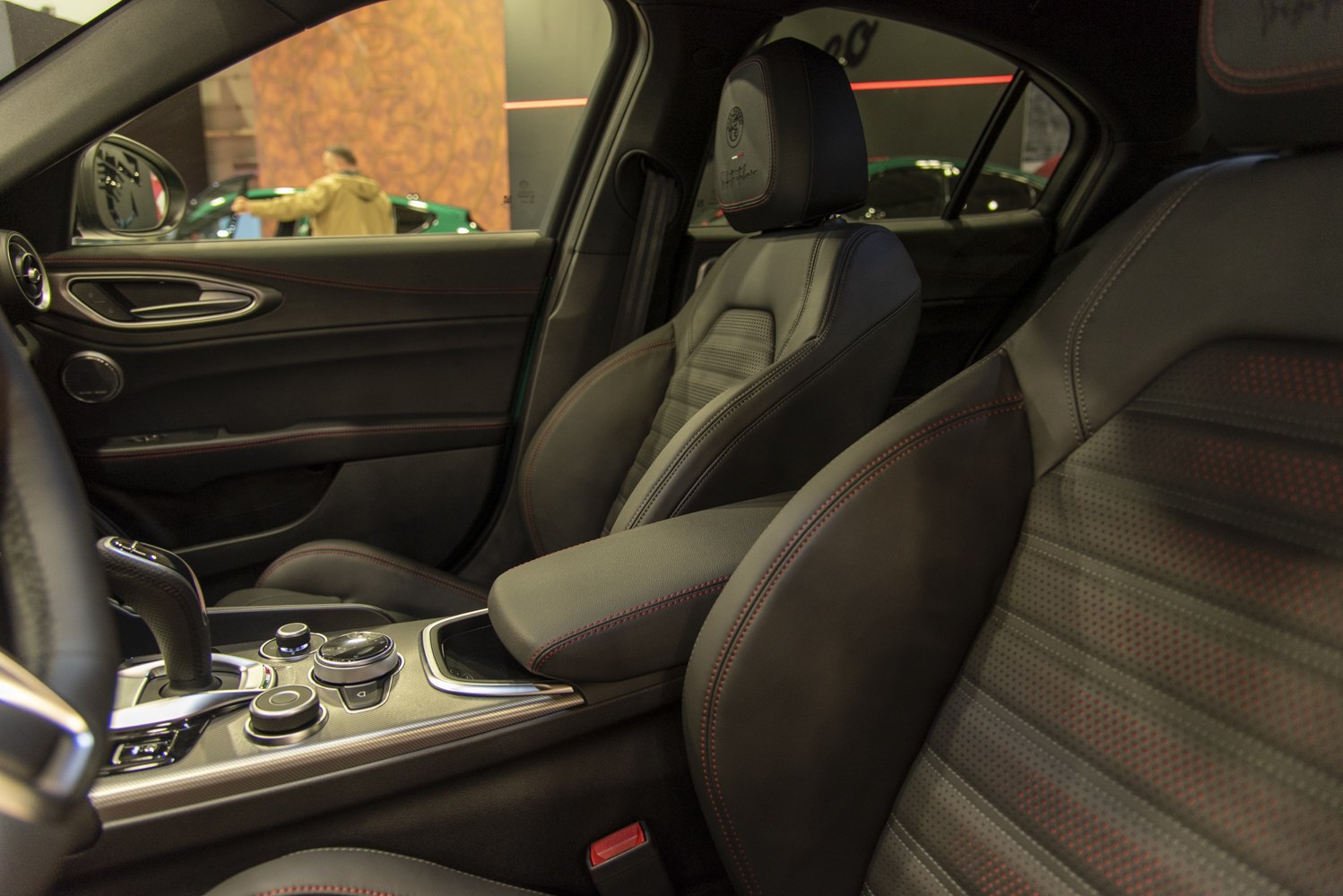 Black leather seats with red stitching and detailed center console controls