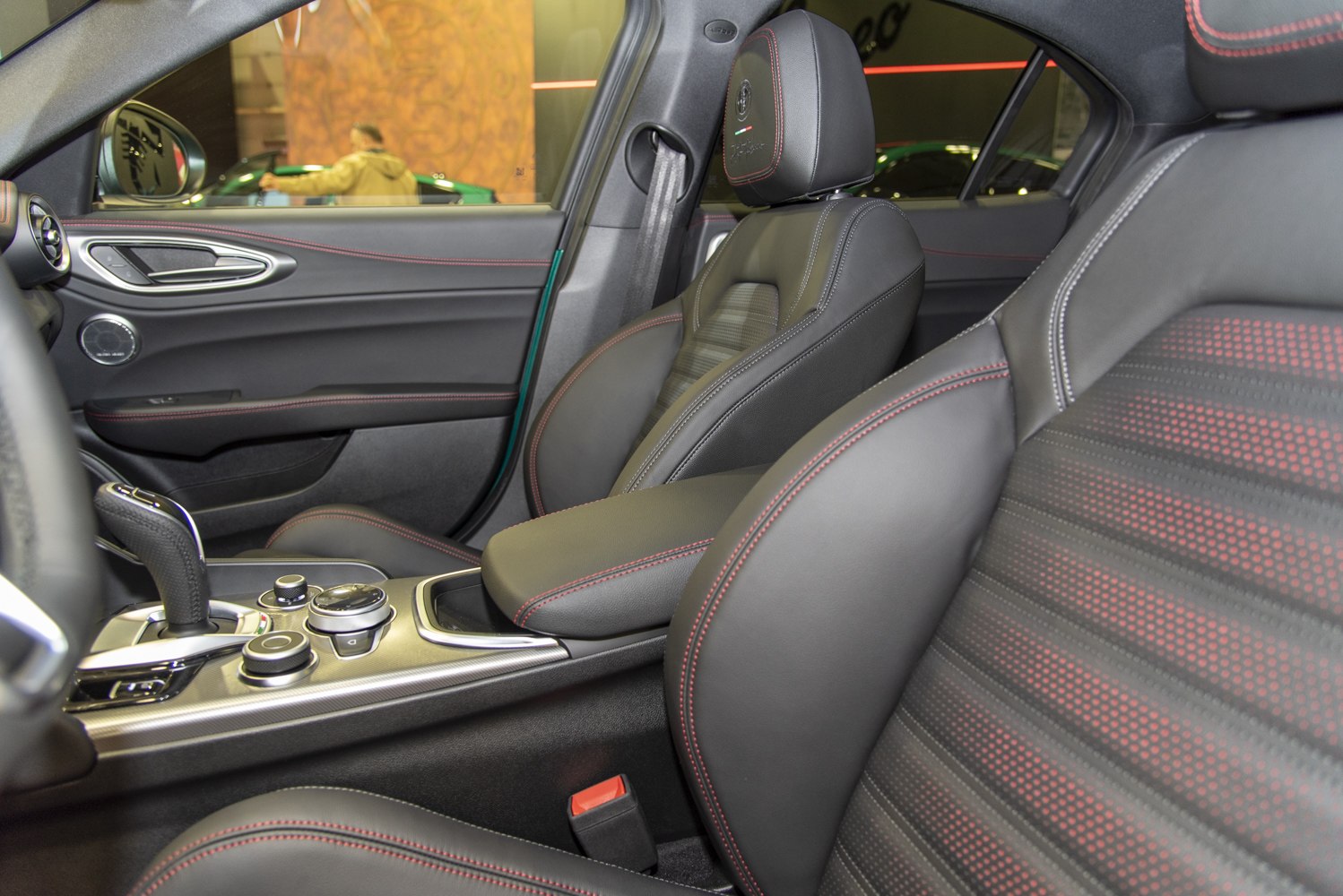 Sporty interior with red-stitched black leather seats and central console