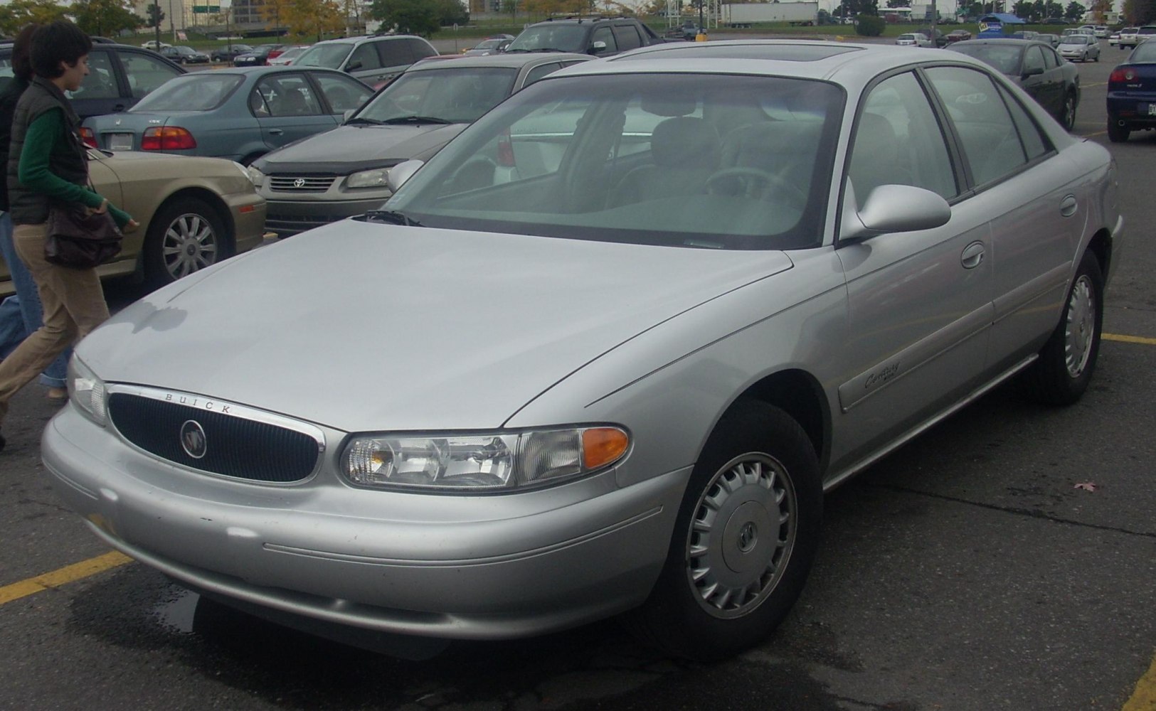 Silver four-door sedan with rounded headlights and chrome grille