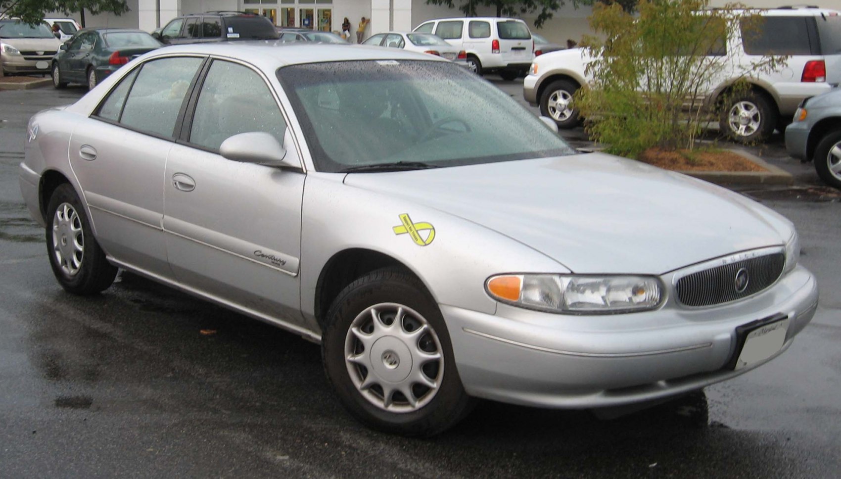 Silver sedan front corner view with alloy wheels and clear headlights