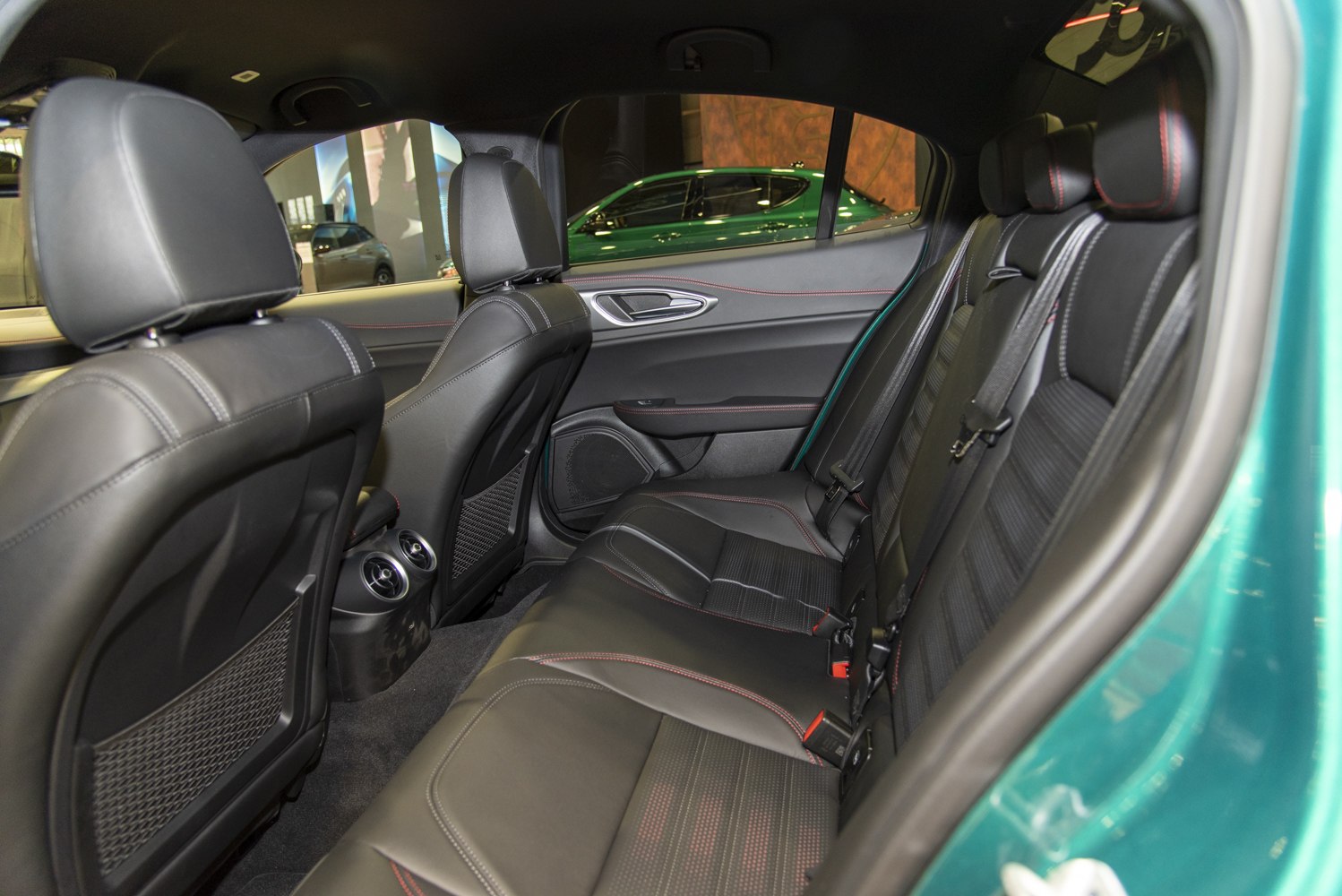 Rear leather seats with red stitching and rear air vents