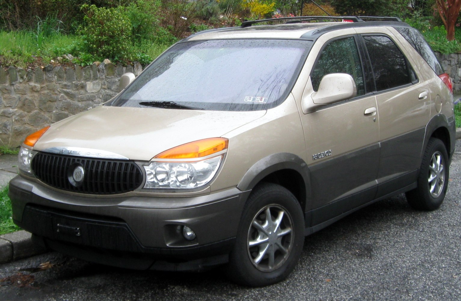 Front three-quarter view of beige SUV with dual round headlights and alloy wheels