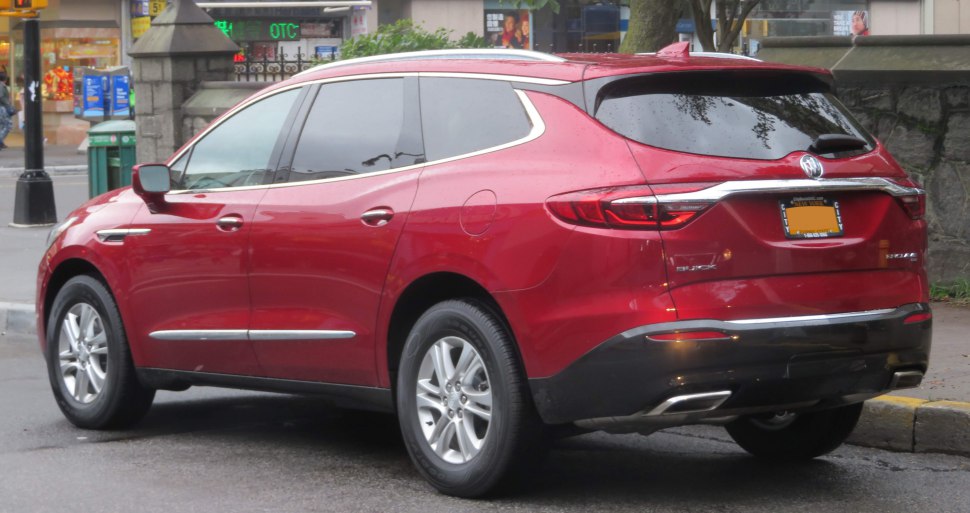 Rear-side view of a red SUV with sleek taillights and dual exhaust pipes