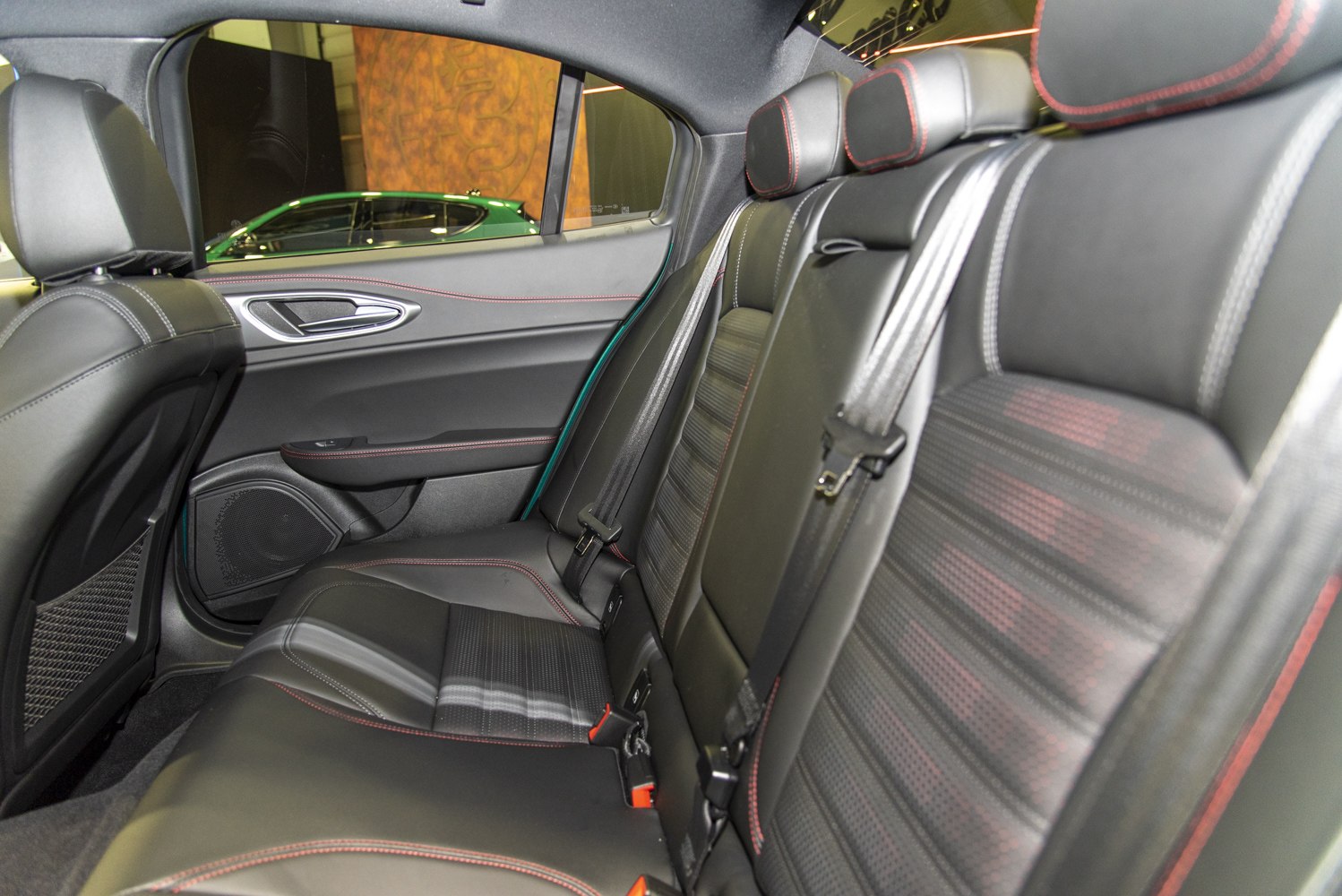 Rear seat interior with black leather and red stitching