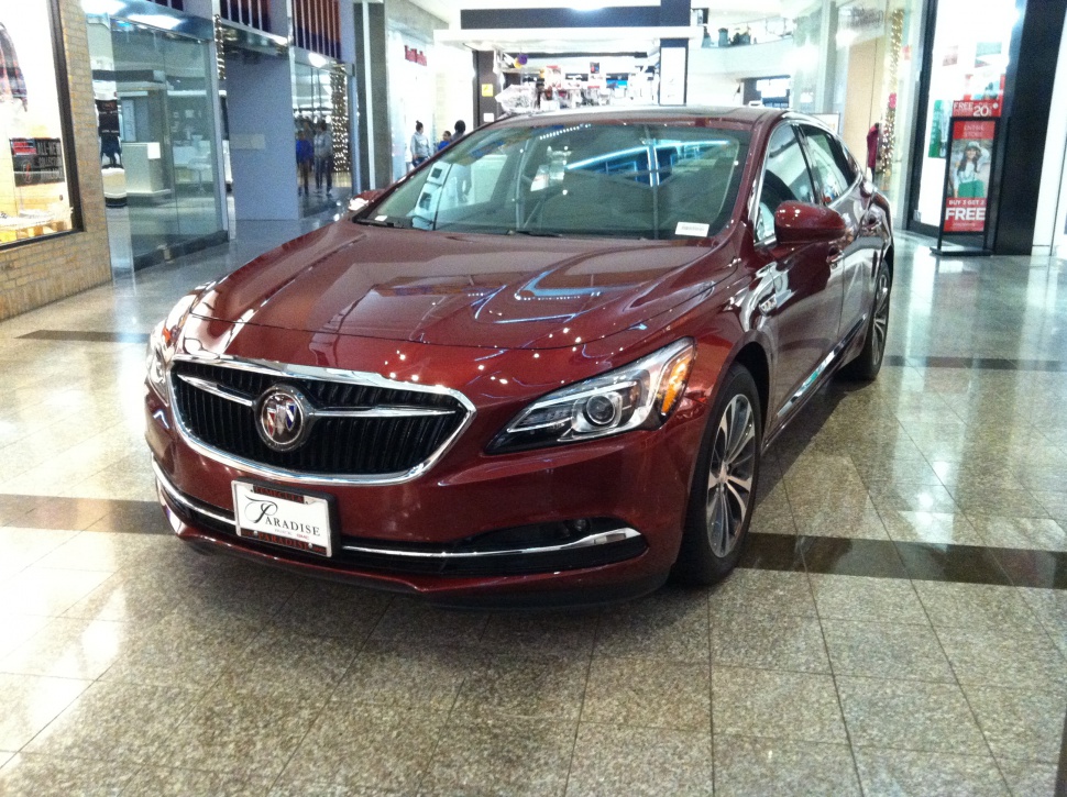 Front angle view of a sedan displayed indoors