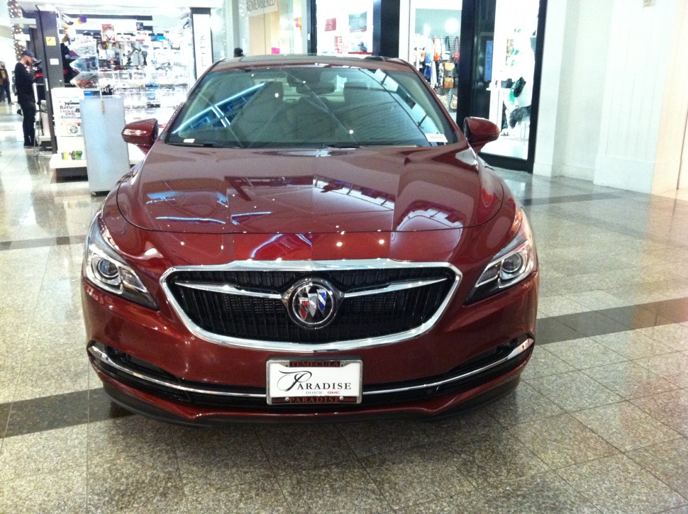 Front view with distinctive grille and headlights in a showroom