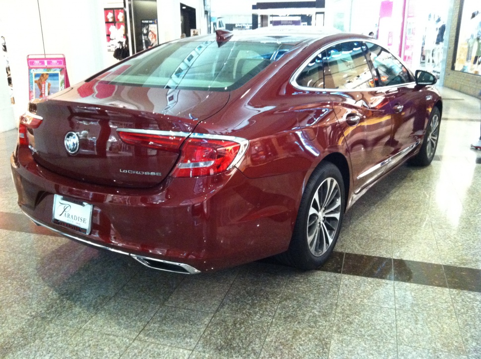 Rear and side view of a sleek burgundy sedan with modern tail lights.