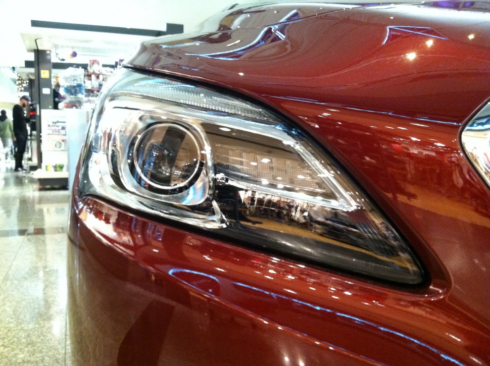 Close-up of a modern car headlight with sleek, detailed design.