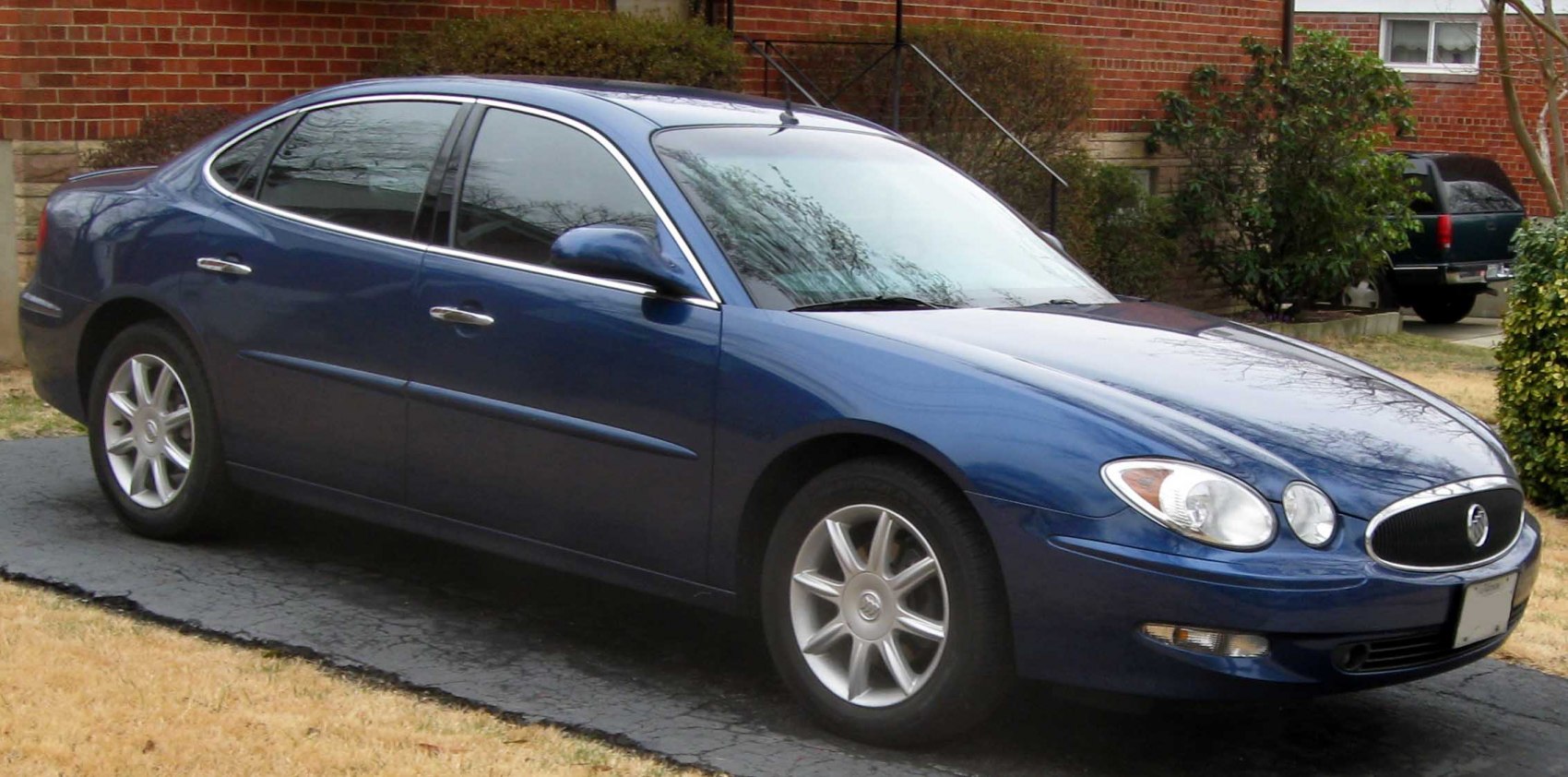 Blue sedan side and front exterior with alloy wheels