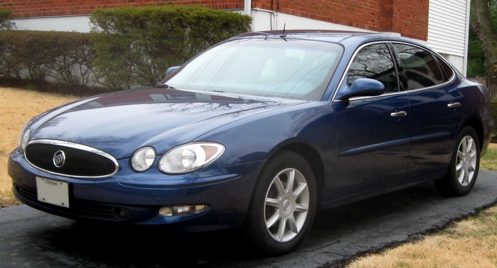 Front and side view of blue sedan with signature grille and alloy wheels