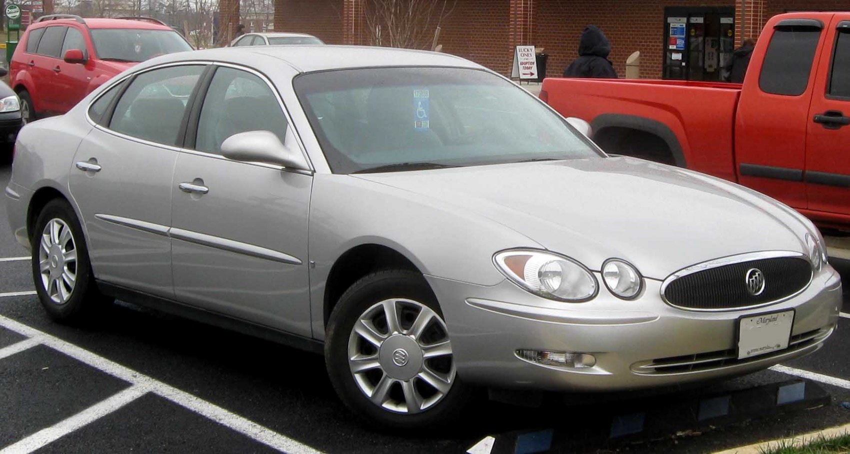 Silver sedan with oval headlights and chrome-accented grille