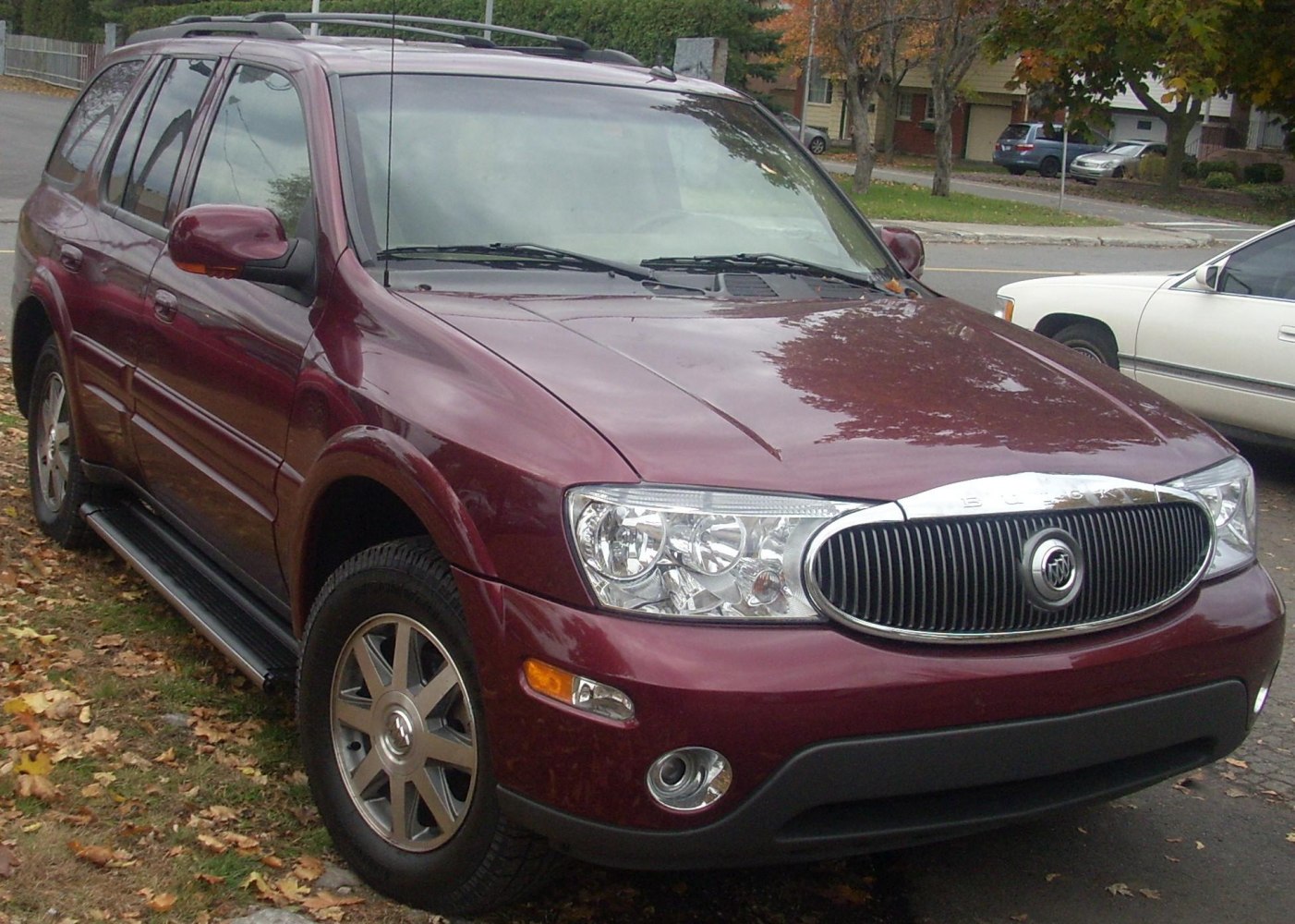 Front angle of SUV with chrome vertical-bar grille and clear lens headlights